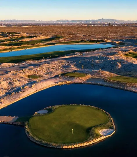 Island green surrounded by water with the Las Vegas skyline in the distance